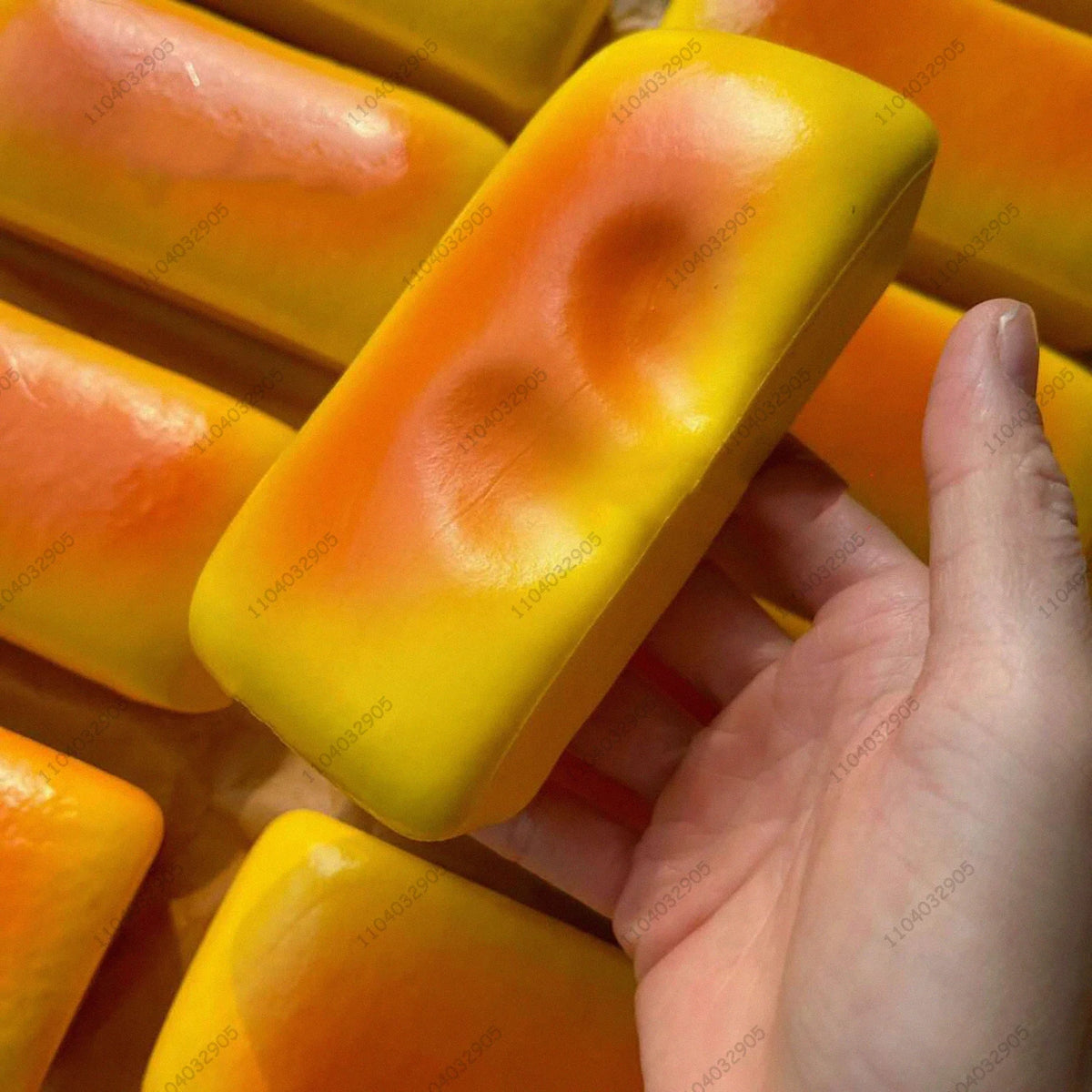 A close-up of several bright yellow and orange squishy toys, showing their smooth texture and vibrant colors.