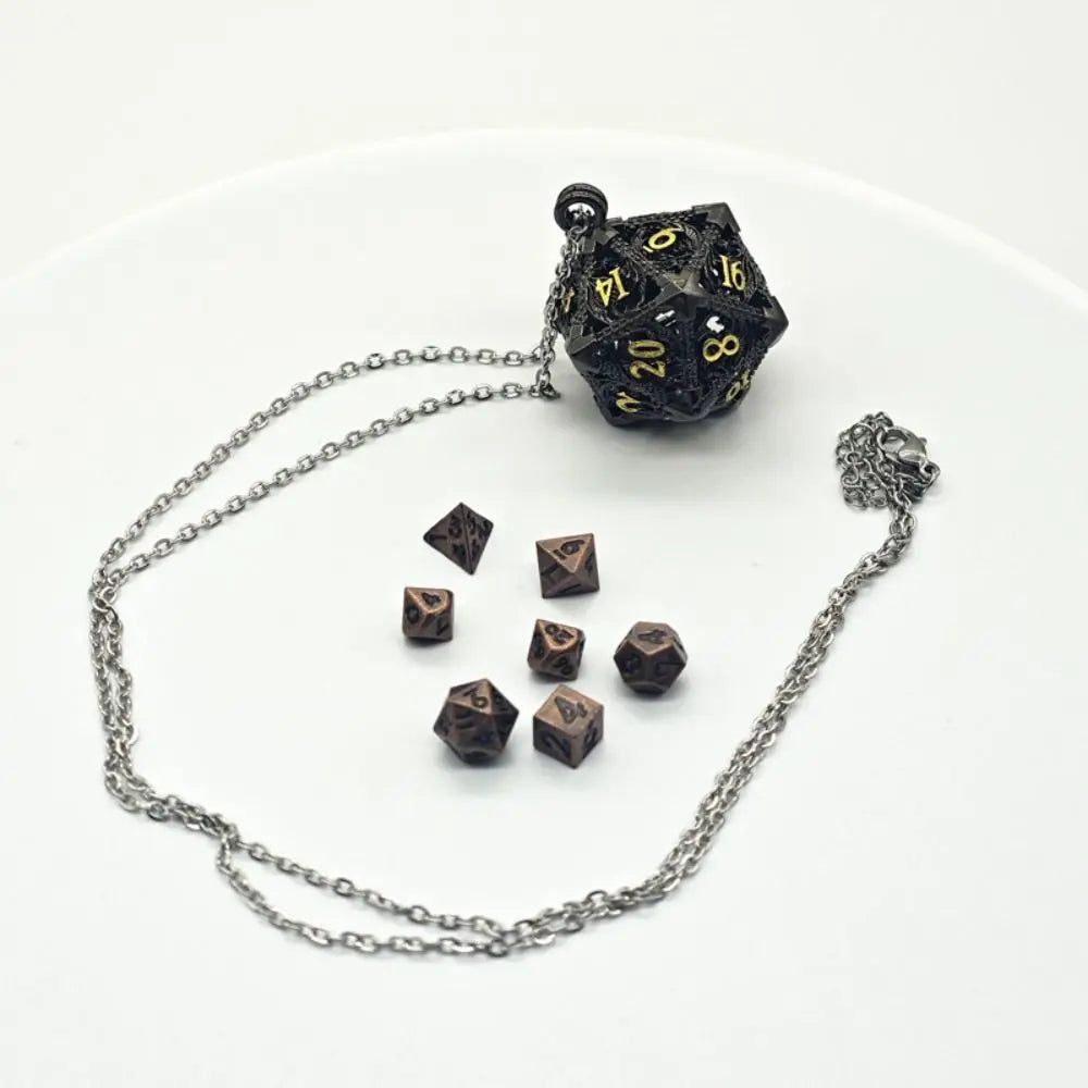 A set of metal polyhedral dice, including a d10, displayed next to a chain with a pendant storage case.