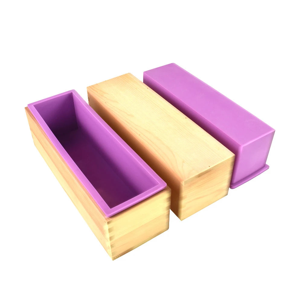 Rectangular silicone soap mold with a purple insert and wooden casing, shown at an angle.