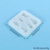 A white silicone mold tray with multiple festive Christmas-themed shapes for jewelry and craft projects.