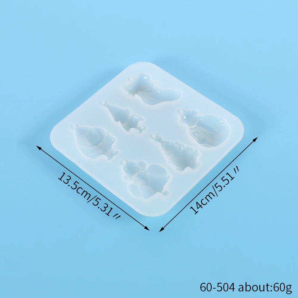 A white silicone mold tray with multiple festive Christmas-themed shapes for jewelry and craft projects.
