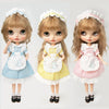 Three dolls wearing vintage lace maid dress sets in blue, yellow, and pink
