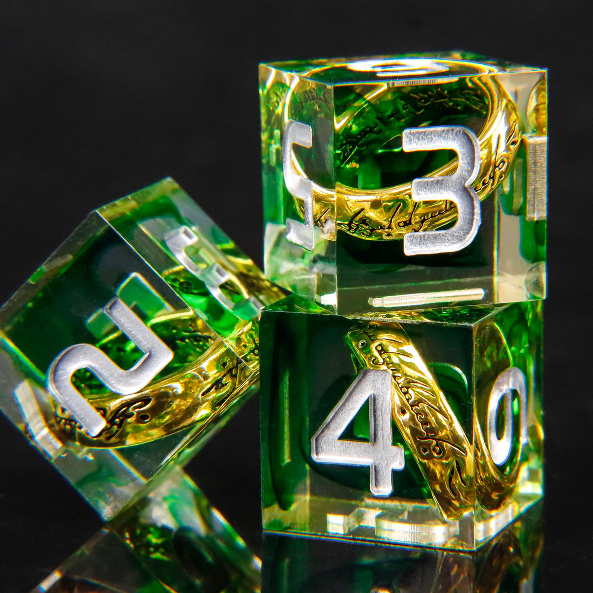 A set of green resin dice featuring golden elven numbers, including a 3 and a 4.