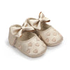 Pair of gold glitter baby girl shoes with bow knots and a soft anti-slip sole