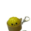 Yellow dumpling squishy keychain featuring a cute face and LED glow.