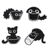A set of four black cat enamel pins featuring various stylized cat faces and silhouettes.