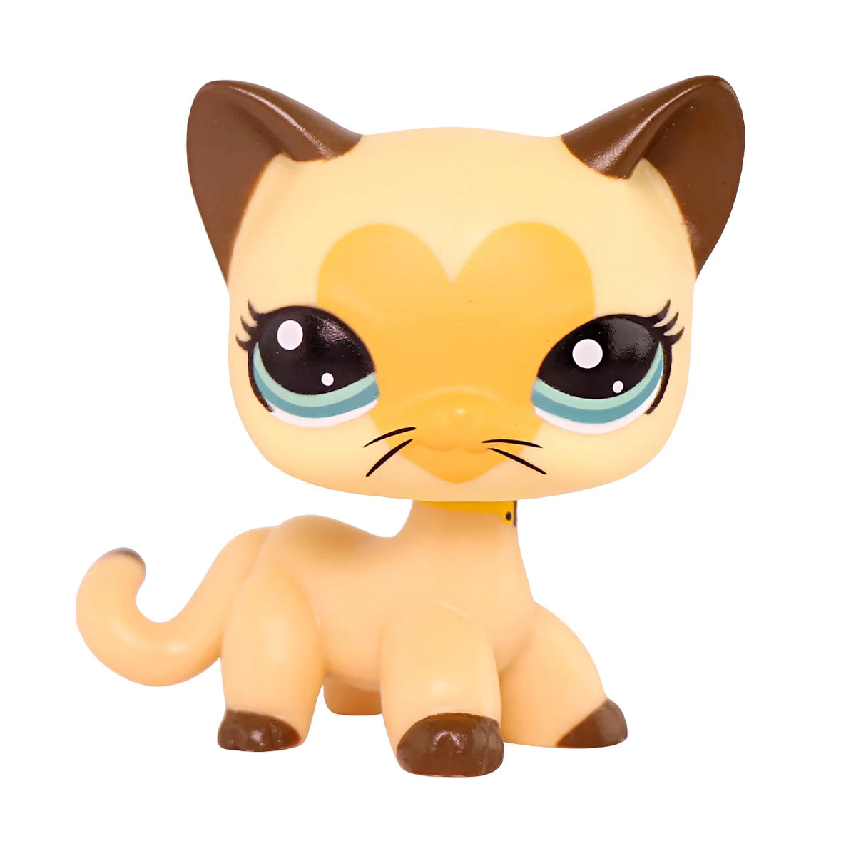 A small, light yellow miniature cat figure with large blue eyes and brown ears.