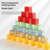 A pyramid of colorful, translucent building blocks demonstrating light refraction and shadow effects.