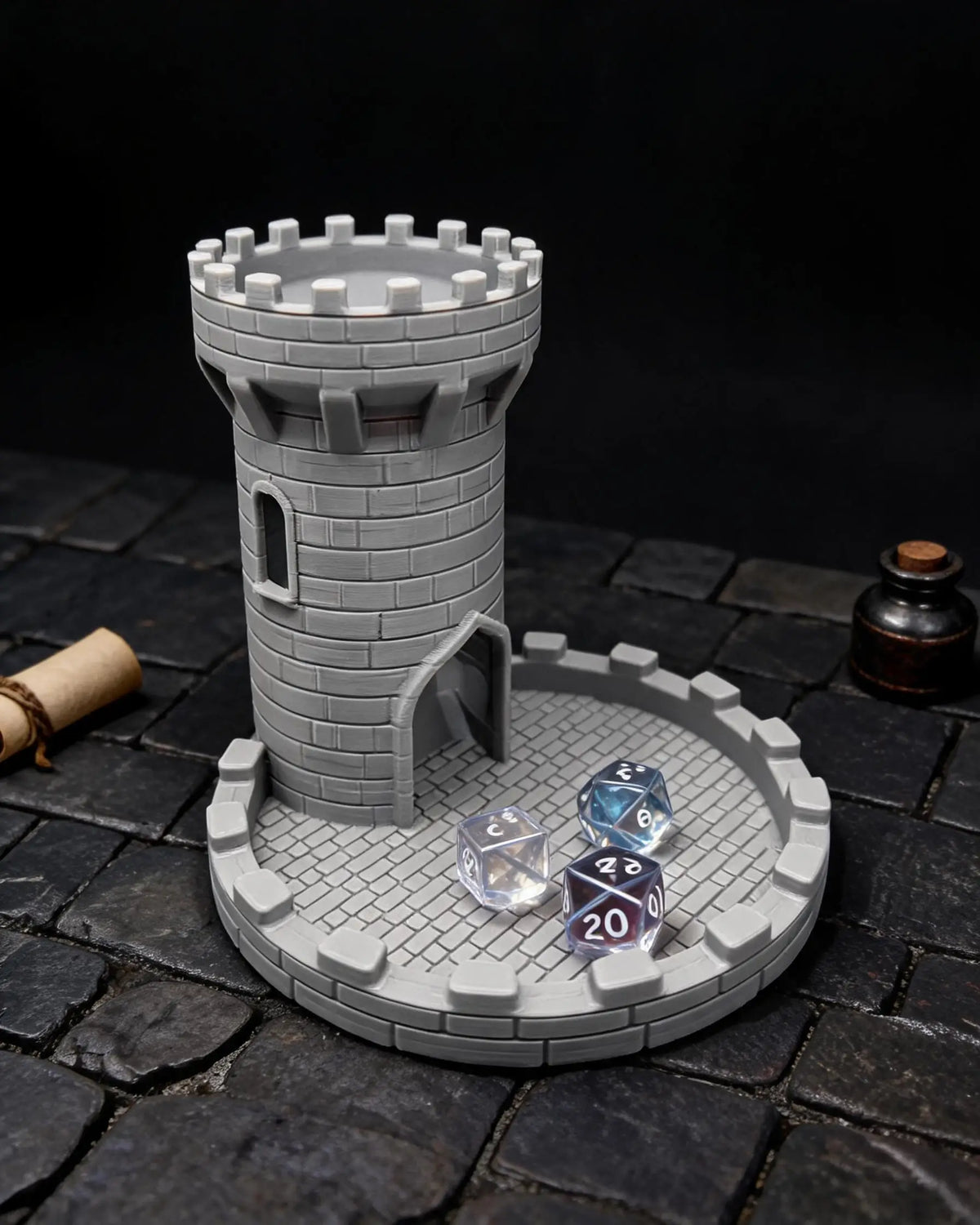 A gray medieval castle tower model with dice resting on a circular tray on a dark stone surface.