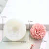 A white silicone mold shaped like a pink flower, used for decorating soap, candles, or cakes.