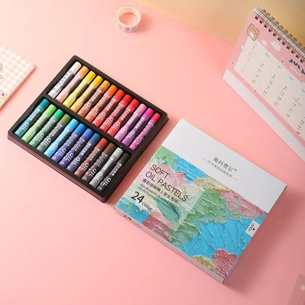 A set of 24 soft macaron colored oil pastels arranged in a wooden box next to the product packaging.