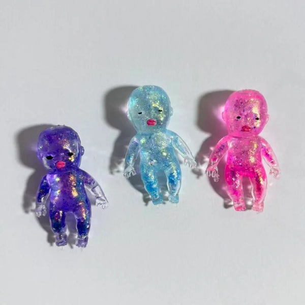 Three squishy fidget toys in blue, purple, and pink colors are displayed against a white background.