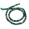 A strand of dark green faceted crystal beads used for jewelry making.