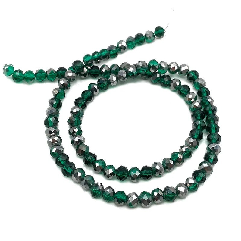 A strand of dark green faceted crystal beads used for jewelry making.