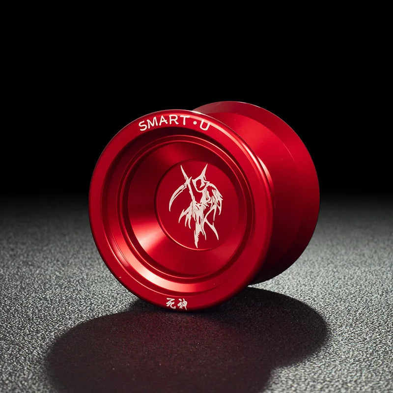 A close-up view of a red aluminum alloy yo-yo with a white dragon emblem on a dark surface.