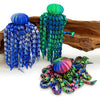 Colorful octopus desktop statue with blue and green tentacles resting on a wooden surface.