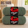 Two skeins of super soft red acrylic yarn are displayed on a light surface.