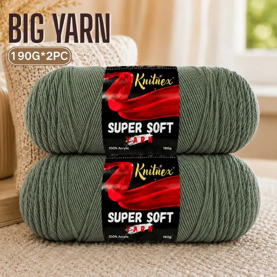 Two skeins of super soft red acrylic yarn are displayed on a light surface.