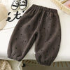 Dark gray fleece-lined pants with a subtle heart print laid flat on a white surface.
