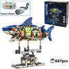 A detailed mechanical shark model built from plastic parts and powered by a motor, displayed on a stand.
