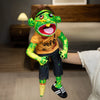 A realistic plush hand puppet resembling a green monster with large teeth and bright yellow skin.