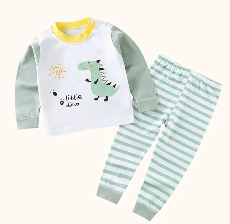 A white and green cartoon cotton pajama set for a child featuring a dinosaur design.