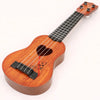A wooden ukulele toy with adjustable tuning pegs and a heart decoration.