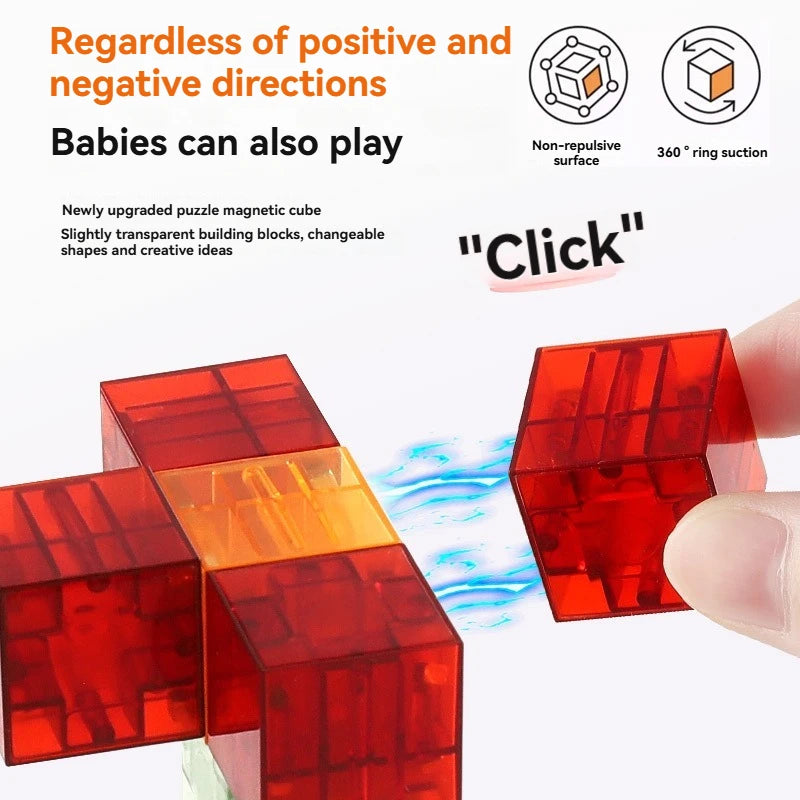 A hand holds a red magnetic building block cube, showing its transparent construction and interlocking shapes.