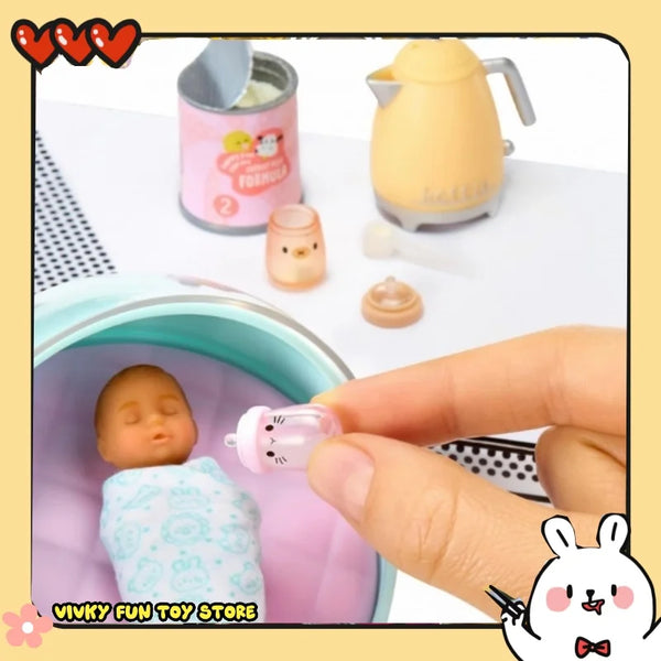 A pink miniature baby food doll toy is being held by a hand next to a yellow teapot and a purple bowl.
