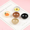 A set of ten miniature dollhouse rice bowls in various earthy and yellow tones displayed on a white card.