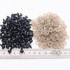 A collection of black and beige plastic safety eyes for amigurumi, measured against a ruler.