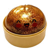 A sparkling, round squishy toy resembling a face with cute eyes and a smile, resting in a light yellow container.