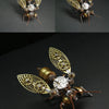 A detailed steampunk mechanical bee model kit featuring brass and silver metal parts with intricate wings.