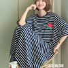A woman models a loose striped short-sleeve lounge dress featuring a watermelon design.