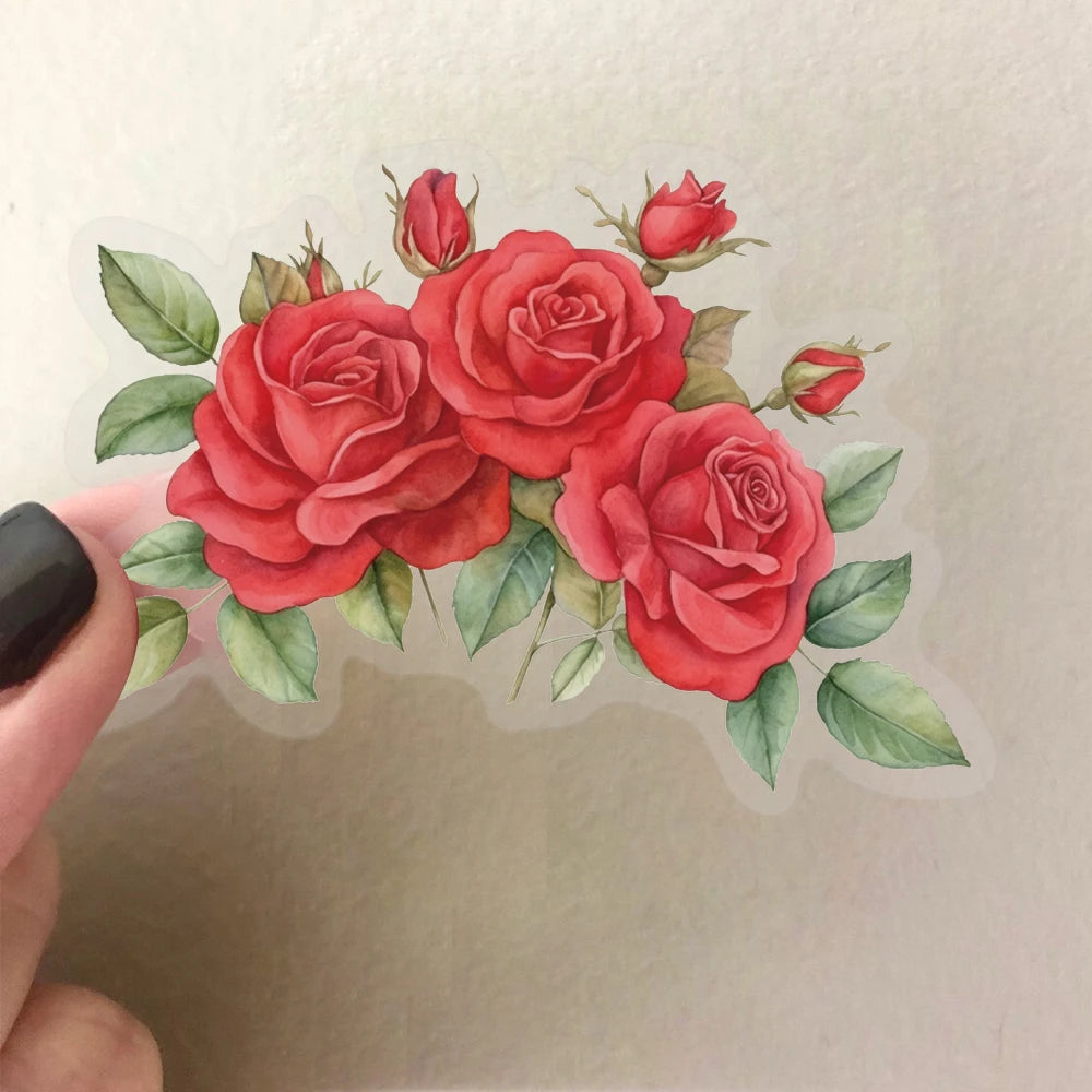 A watercolor illustration of several vibrant red roses and green leaves on a clear sticker sheet.