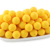 A pile of bright yellow round silicone beads for jewelry making and DIY crafts.
