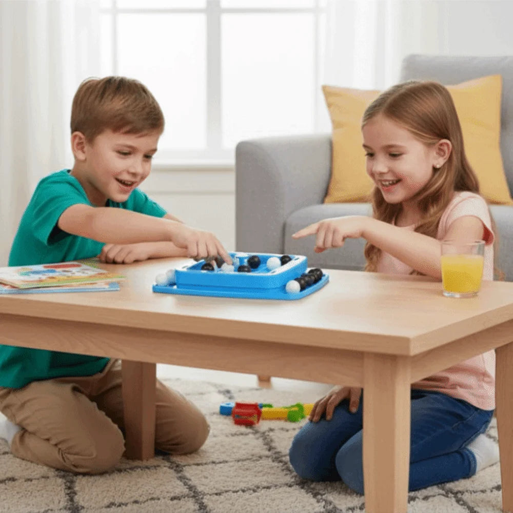 Two children playing with a blue strategy board game on a wooden table indoors.