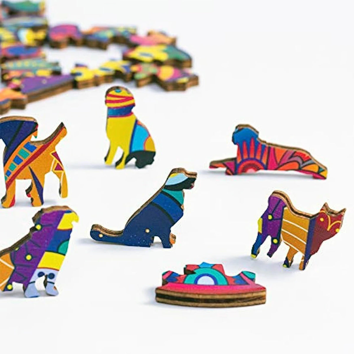A collection of colorful wooden puzzle pieces shaped like various animals, including a wolf and other irregular animal forms.