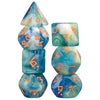 A set of seven translucent blue and green glitter polyhedral dice stacked vertically.