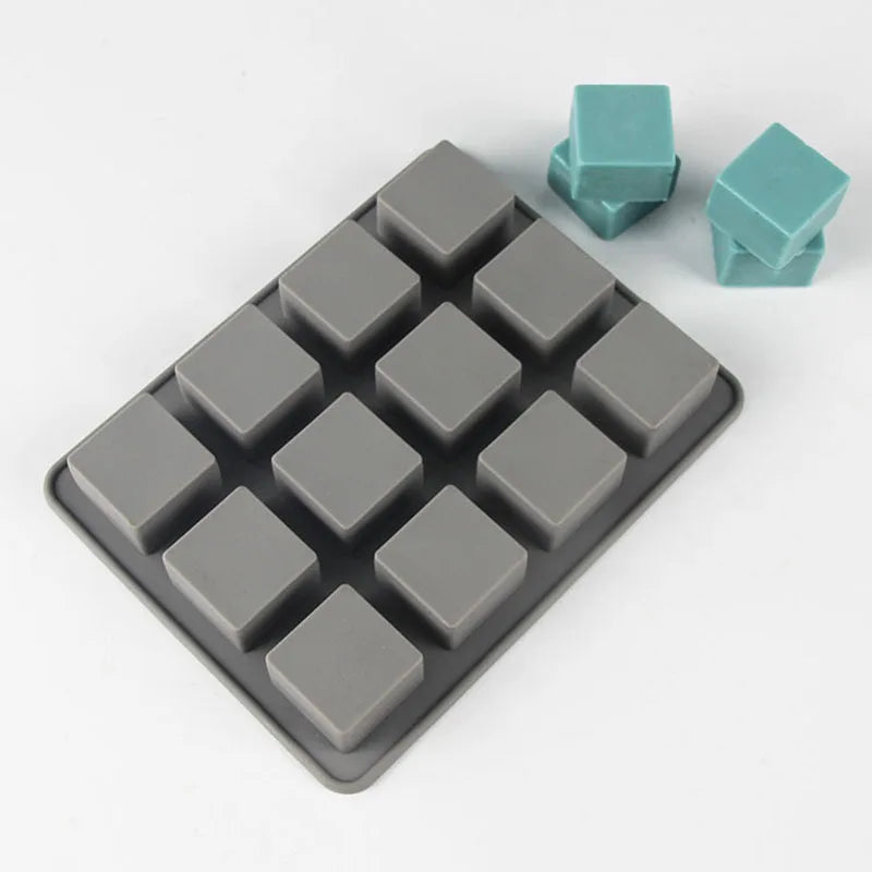 A square silicone soap mold with 12 cavities is shown, featuring gray and teal colored silicone pieces.