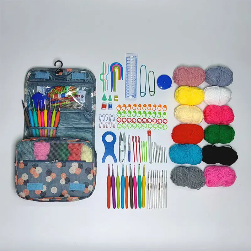 A complete crochet kit with various yarn colors, hooks, needles, and accessories displayed in a storage bag.