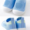 A pair of light blue breathable mesh slip-on sneakers for toddlers shown from the top view.