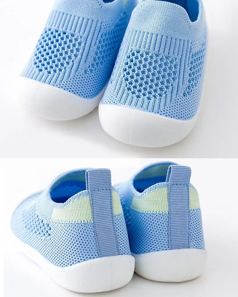 A pair of light blue breathable mesh slip-on sneakers for toddlers shown from the top view.