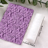 A roll of purple floral and leaf clay texture rollers resting on a white cloth.