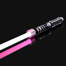 An RGB metal lightsaber with a pink blade and black hilt, shown diagonally against a black background.