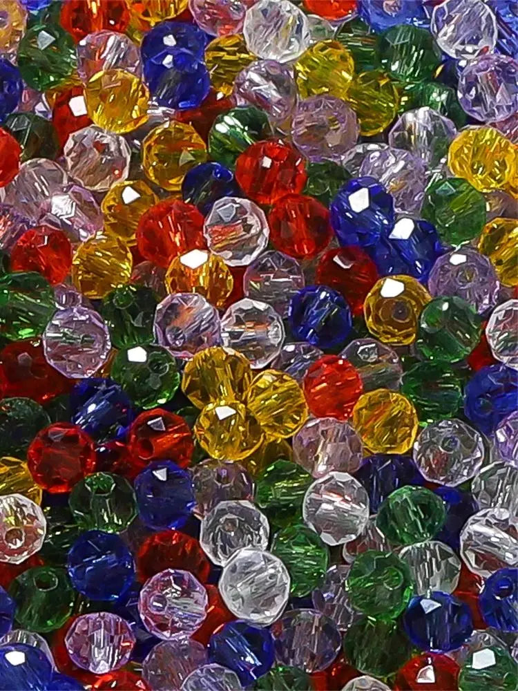 A close-up view of a mixed assortment of faceted rondelle glass beads in various colors like red, green, yellow, and blue.