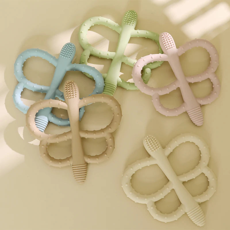 A collection of soft silicone butterfly teethers in various pastel colors, including blue, green, pink, and white.