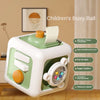 A white and green children's busy ball cube with various features like a whistle, music, and steering wheel.