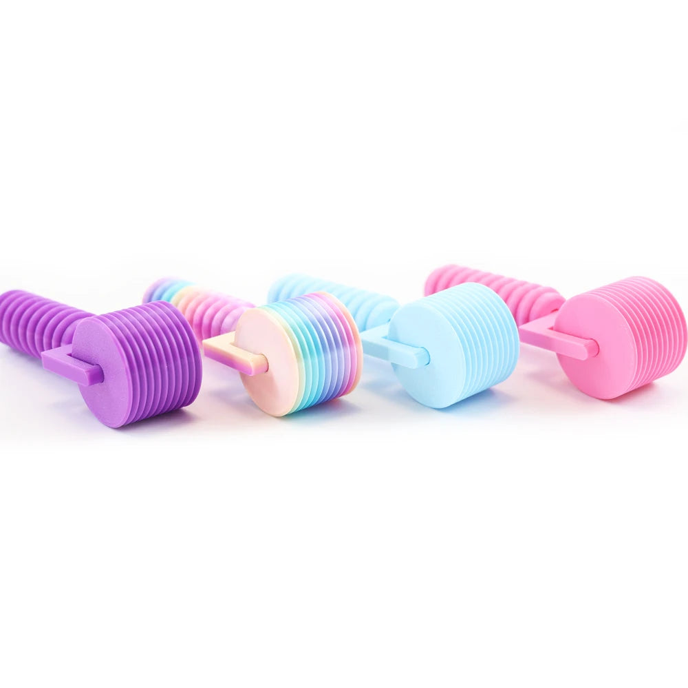A collection of colorful, purple and pink detachable diamond painting rollers arranged in a row.