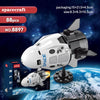 A white and black model spacecraft helicopter built from building blocks, displayed against a backdrop of Earth.